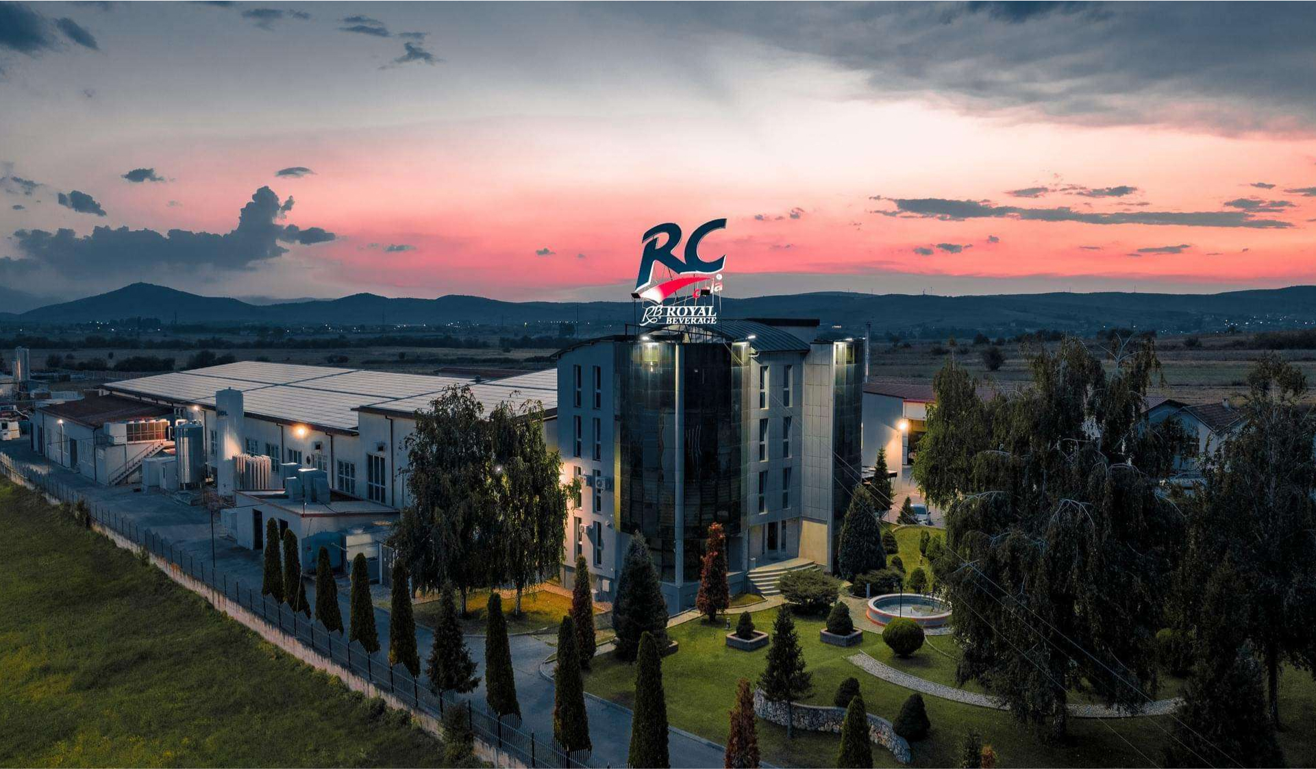 RC Cola headquarters at sunset with lit signage