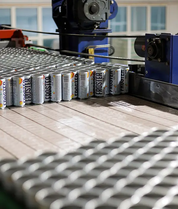 Aluminum cans being guided through the canning section of the beverage production line