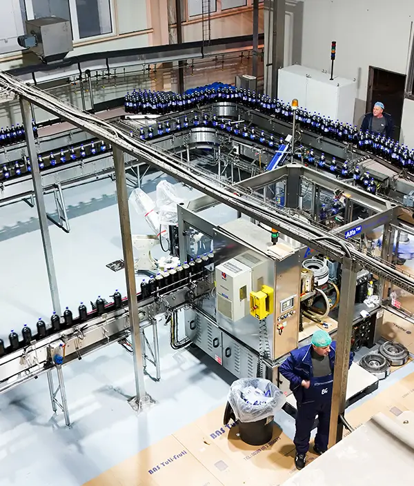 Wide view of the bottling system and factory equipment with RC Cola bottles in process